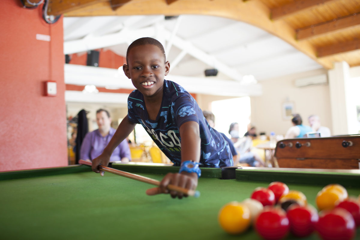 Boy playing pool
